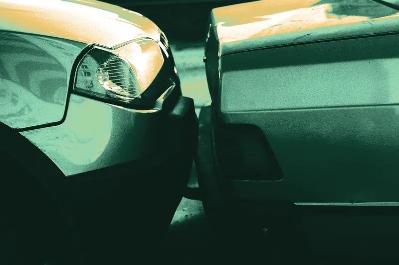Two cars touching bumpers after a rear-end collision