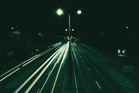 Headlight and taillight trails on a highway at night